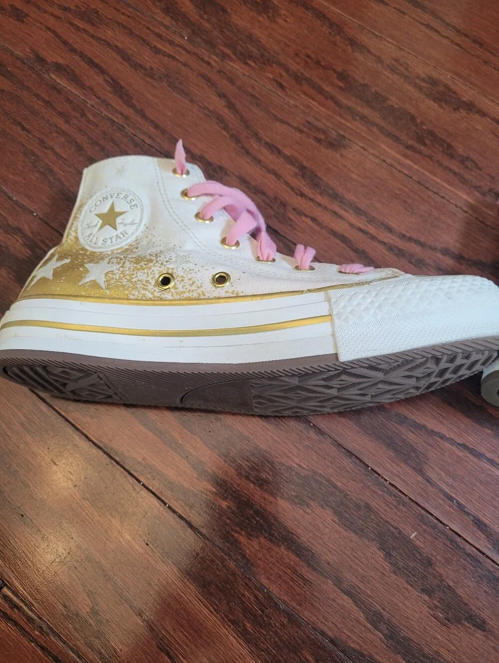 White High-Top Converse Chuck Taylor Sneakers with Pink Laces